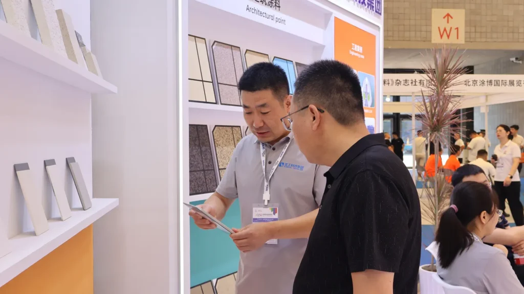Technical conversation at a SINGAL PAINT exhibition stand