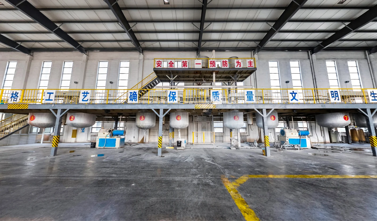Mixing vessels and steel access platforms in the coating workshop