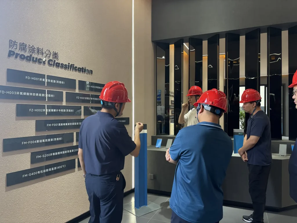 Visitors viewing an industrial coating product display