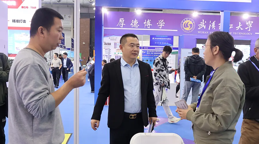 Visitors discussing coating materials at a trade exhibition