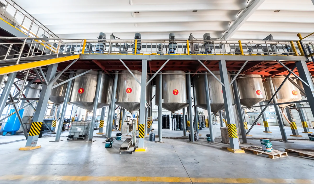 Coating production equipment beneath a steel access platform