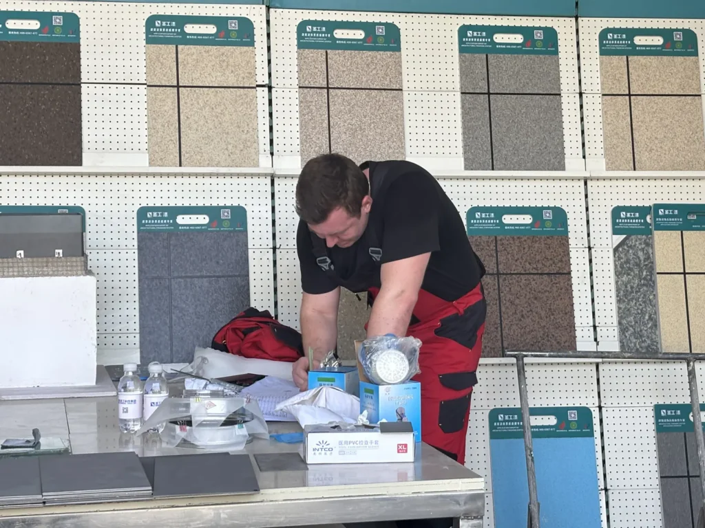 Visitors reviewing coating materials in a technical setting