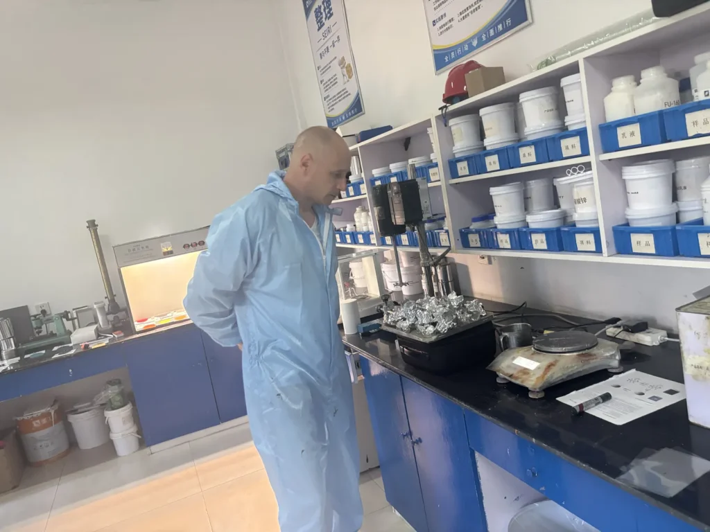 A visitor reviewing coating materials in a laboratory setting